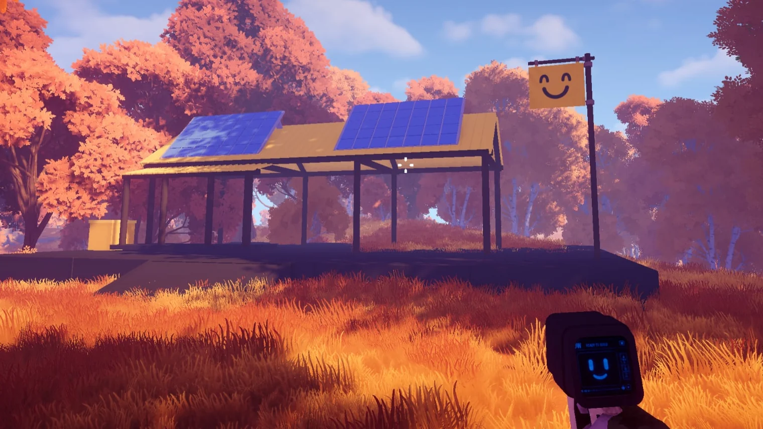A camp shelter with two solar panels on its roof and a smiley-face banner, in an autumn clearing, seen past the charge pack in the player's hand.